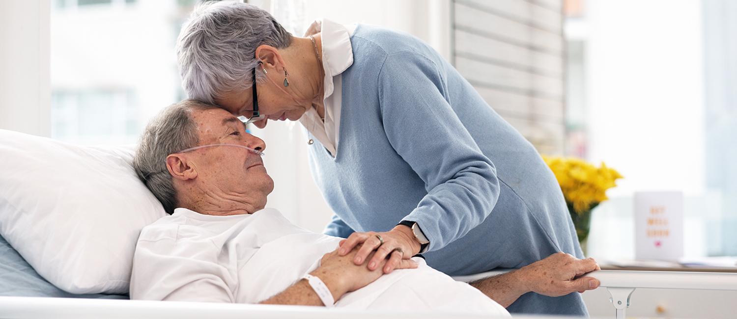 wife comforting husband in hospital bed wife comforting husband in hospital bed